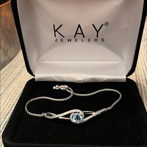 Kay Jewelers Bracelet with diamonds around and a beautiful blue sapphire center!